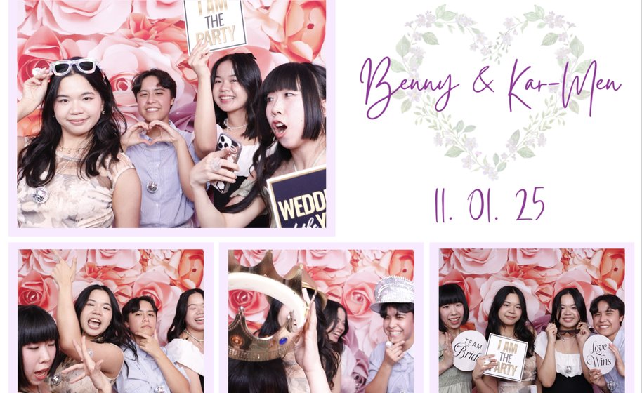 Friends posing joyfully at wedding photo booth with floral backdrop