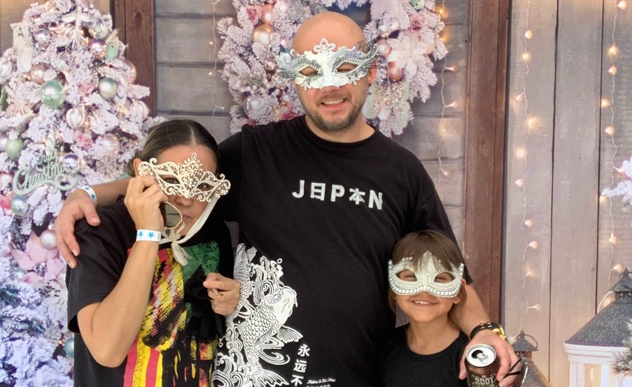 Happy friends taking group selfie at photo booth