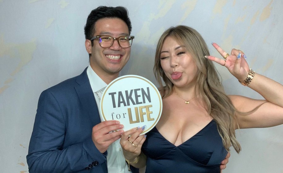 Couple posing in elegant wedding photo booth