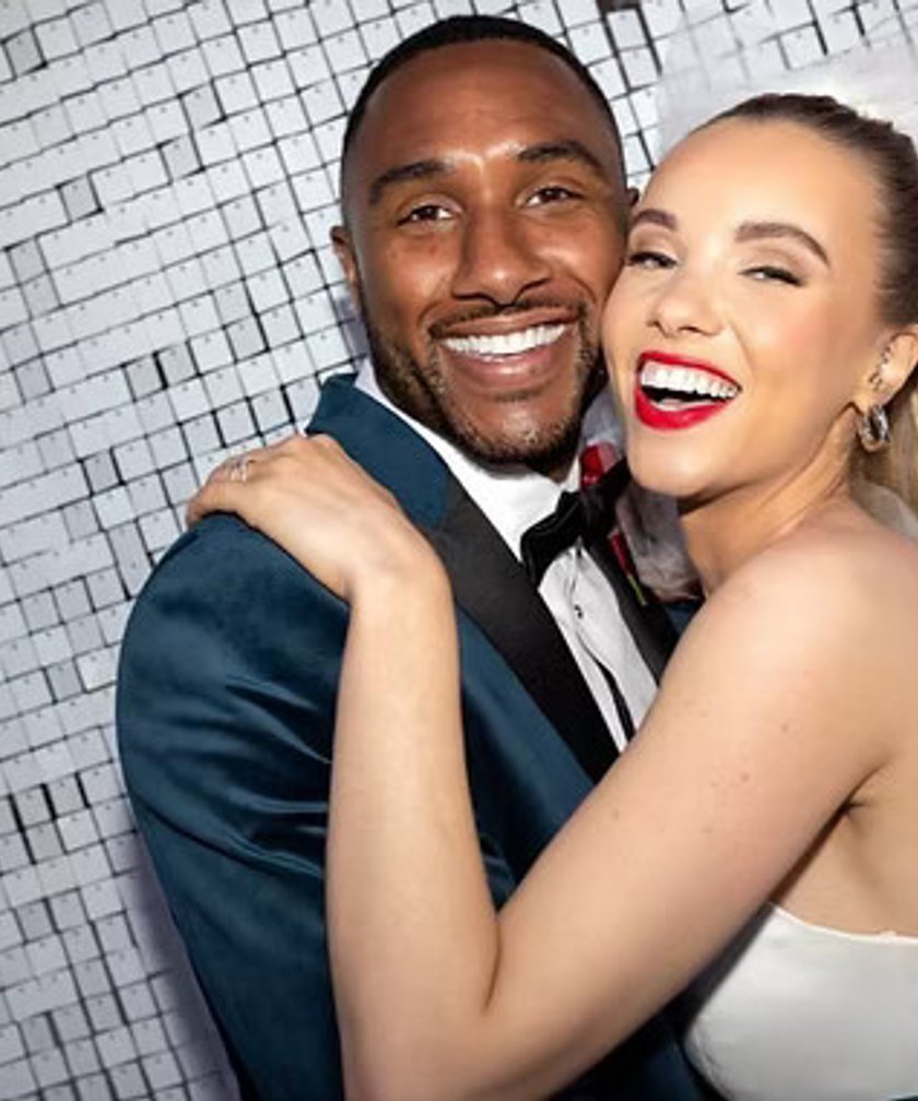 Happy couple holding photo booth print