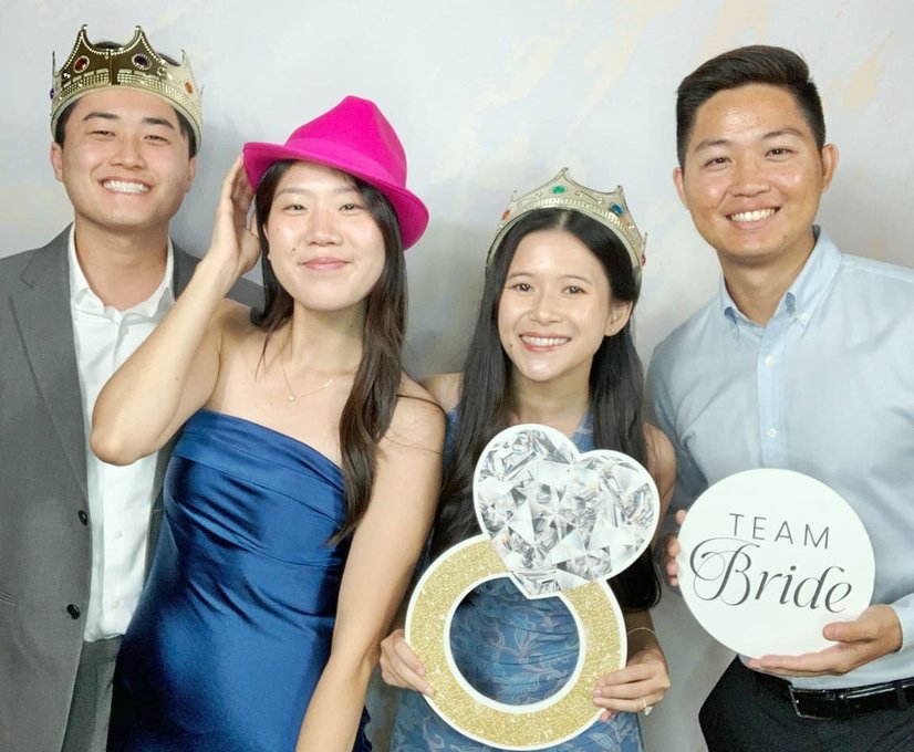 Guests smiling with props in photo booth